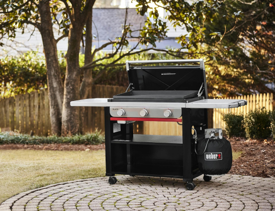 weber slate grill in the middle of a backyared patio